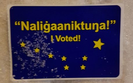 Sticker in snow reads "'Naligaaniktna!' I voted!" 